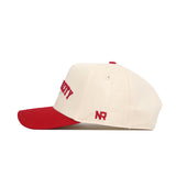 The Salt Lake City Hometown Hat by No Rivals is a cream-colored snapback with a red brim and side text "NR." Made from high-quality cotton, it features a classic six-panel fit and partially visible main text on the front.