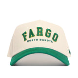 The Fargo Hometown Hat by No Rivals is a white snapback with “FARGO” in bold green and yellow, “NORTH DAKOTA” in small green text, a structured fit, green curved brim, and premium cotton construction.