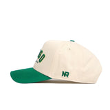 The No Rivals Fargo Hometown Hat is a cream snapback with a green brim and top button, green NR embroidery on the side, and front text in green with a yellow outline. Made from high quality cotton with a structured fit.