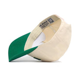 The Fargo Hometown Hat by No Rivals is a beige cotton baseball cap with a green brim, white sweatband, and an inner QR code label reading NO RIVALS. Shown upside down to highlight its structured fit and comfortable quality.