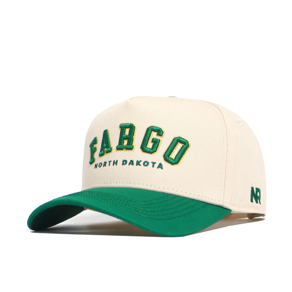 The Fargo Hometown Hat by No Rivals is a beige snapback made from high-quality cotton, with "FARGO NORTH DAKOTA" embroidered in green and yellow, a green brim, and NR initials stitched on the side for structure.