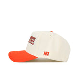 The No Rivals Oklahoma State Retro Block Hat is a white, structured baseball cap with an orange brim. It features red and blue stitched text on the front, NR initials in red on the side, and is officially licensed. The background is plain white.