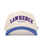 The No Rivals Lawrence Hometown Hat is a white and blue snapback featuring "LAWRENCE" in bold blue and red letters and "KANSAS" in smaller blue embroidery, made from high-quality cotton with a structured, comfortable fit.