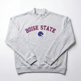 The No Rivals Boise State Mock Neck is a light gray oversized sweatshirt with Boise State in red and blue lettering and the Broncos logo centered on the chest, made from heavyweight cotton and shown laid flat on a white background.
