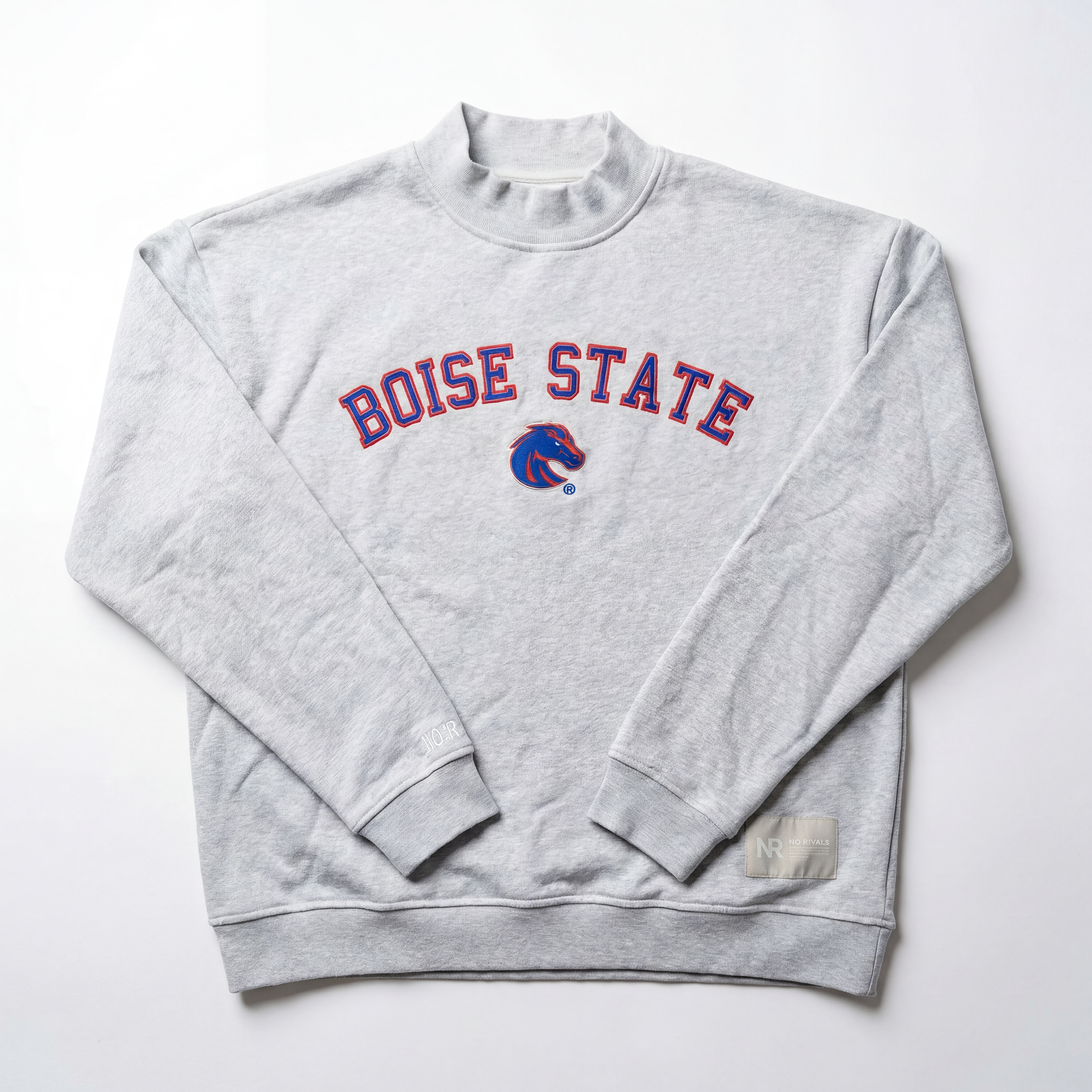 The No Rivals Boise State Mock Neck is a light gray oversized sweatshirt with Boise State in red and blue lettering and the Broncos logo centered on the chest, made from heavyweight cotton and shown laid flat on a white background.