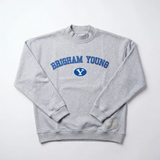 The BYU Mock Neck by No Rivals is a light gray oversized crewneck sweatshirt in heavyweight cotton, featuring BRIGHAM YOUNG and a blue oval with a white Y on the front, shown laid flat on a white background.