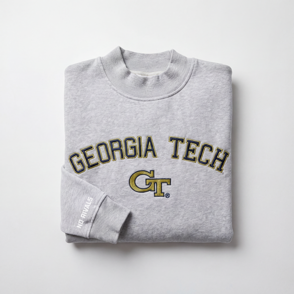 The Georgia Tech Mock Neck by No Rivals is a heavyweight gray, oversized sweatshirt with GEORGIA TECH and the GT logo in yellow and black on the front, plus "NO RIVALS" text on the sleeve, shown folded on a plain white background.