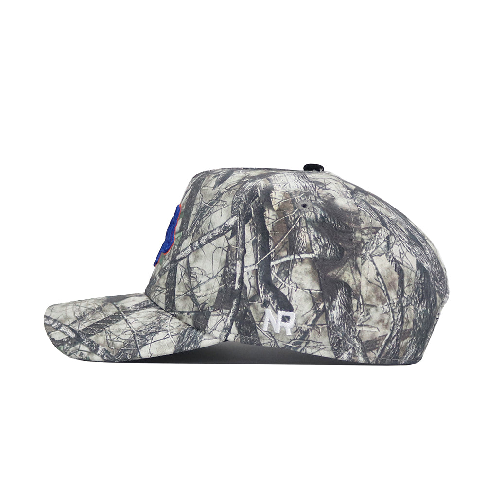 The No Rivals Boise State Outland Hat features a side view of its camouflage pattern, curved brim, structured fit, and an embroidered white NP logo near the back.