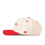 Show off your gameday style with the No Rivals Wisconsin Badgers Vintage Hat—a cream-colored cap featuring a bold red brim, red stitching, and an embroidered NR logo on the side. The front displays part of “WISN” along with an additional embroidered logo for extra flair.