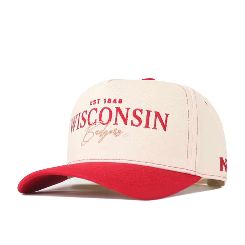The Wisconsin Badgers Vintage Hat by No Rivals is a beige and red baseball cap featuring a bold, embroidered Wisconsin Badgers logo with “EST 1848” in striking red and gold on the front. It sports a vibrant red bill, classic sporty detailing, and an adjustable snap back closure for the ideal gameday fit.
