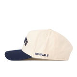 Show your Montana State pride with the Right Side Up Bobcats Hat - Classic by No Rivals. This cream-colored baseball cap features a navy blue brim and an embroidered NO RIVALS logo in navy on the side, making it perfect for your next Gameday Fit. It also includes a classic snap back closure for adjustable comfort.