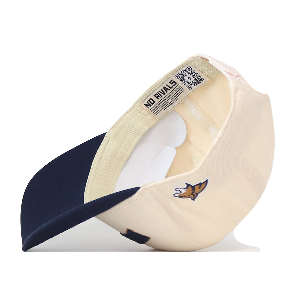 A beige and navy Right Side Up Bobcats Hat by No Rivals, featuring a bold embroidered fox logo on the brim, “NO RIVALS” text on the inside band, and a crisp white inner lining with visible stitching—perfect for completing your ultimate gameday Montana State fit.