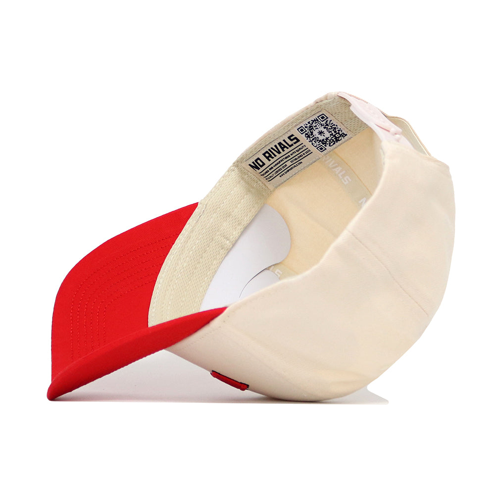The Lincoln Hometown Hat by No Rivals is a cream and red structured baseball cap shown upside down, displaying its NO RIVALS label and a QR code on the inner band. Made from high quality cotton, it offers comfort and durability.
