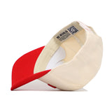 The Lincoln Hometown Hat by No Rivals is a cream and red structured baseball cap shown upside down, displaying its NO RIVALS label and a QR code on the inner band. Made from high quality cotton, it offers comfort and durability.