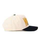 The No Rivals Missouri Tigers Stride Hat, featuring a cream-colored snapback design with a black curved brim, is shown from the side. Yellow embroidered logos are partially visible on the front panel.
