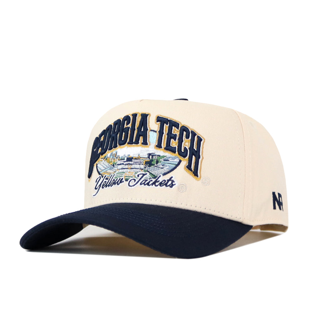 Show your school pride in the No Rivals Georgia Tech Yellow Jackets Stadium Hat, a beige and navy baseball cap featuring an embroidered Georgia Tech Yellow Jackets logo and a detailed cityscape on the front. The side is finished with ’47 embroidery, while an adjustable snap back ensures all-day comfort and a perfect fit for gameday.