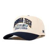 Show your school pride in the No Rivals Georgia Tech Yellow Jackets Stadium Hat, a beige and navy baseball cap featuring an embroidered Georgia Tech Yellow Jackets logo and a detailed cityscape on the front. The side is finished with ’47 embroidery, while an adjustable snap back ensures all-day comfort and a perfect fit for gameday.