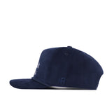 Side view of the No Rivals Back Nine Cord Hat in navy. This cotton corduroy baseball cap features a flat brim, subtle embroidered logos near the back, a snapback closure, and a button on top. Background is plain white.