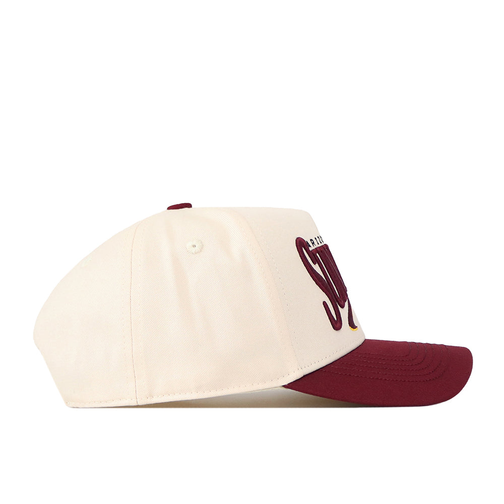 The No Rivals Arizona State Sun Devils Stride Hat is a cream-colored baseball cap crafted from high-quality cotton, featuring a maroon brim and partially visible maroon embroidered lettering on the side. Designed with a structured fit, it is shown from the left angle.