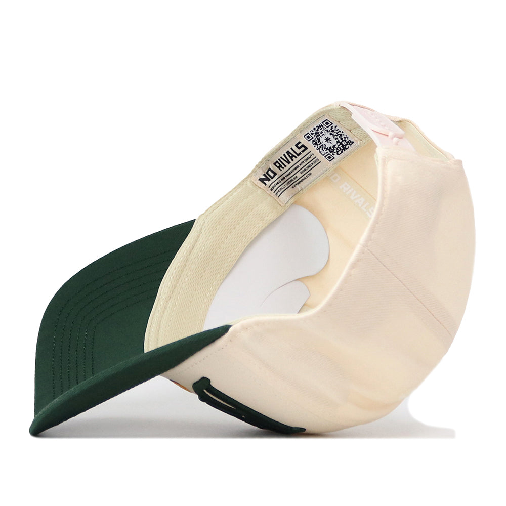 The Baylor Bears Stride Hat by No Rivals is displayed upside down, highlighting the inside label with the NO RIVALS text and a visible QR code. This officially licensed snapback features a cream crown with a dark green bill and finely embroidered logos for added authenticity.