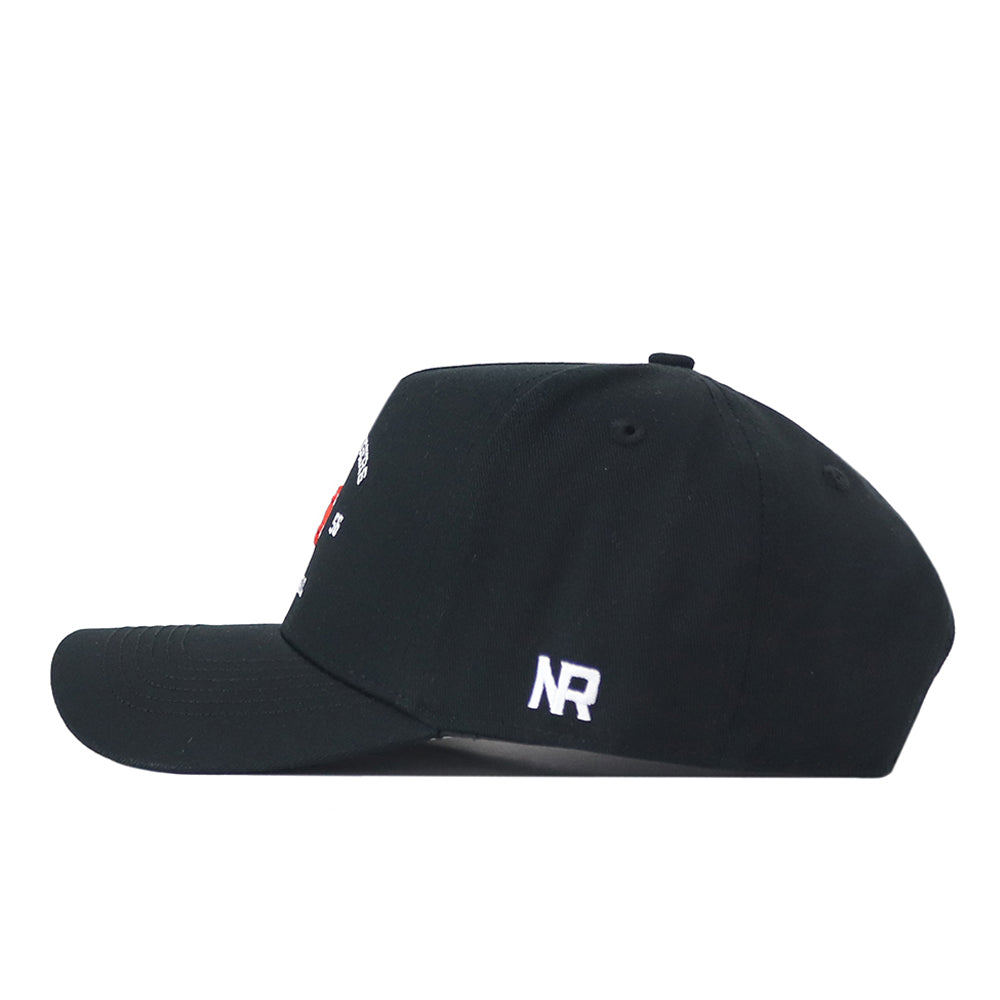 The No Rivals Auburn Outlaw Hat in black is shown from the side, featuring a white embroidered NR logo near the back. The front and top include ventilation holes, while other details are not visible from this angle.