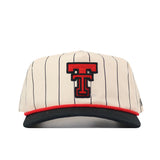 Introducing the Texas Tech Pinstripe Hat from No Rivals—a cream baseball cap featuring classic black pinstripes, a sleek black bill, bold red trim, and a prominent red and black “T” logo on the front. Designed for versatile comfort with an unstructured fit and an adjustable snap back closure, this hat offers a one-size-fits-most solution for everyday wear.