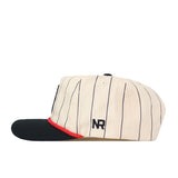 Side view of the Texas Tech Pinstripe Hat by No Rivals—this cream-colored baseball cap features thin black vertical stripes, a black brim with a red accent, and “NR” embroidered on the side. Designed with an unstructured fit and an adjustable snap back closure, this cap offers easy styling and a one-size-fits-most design.