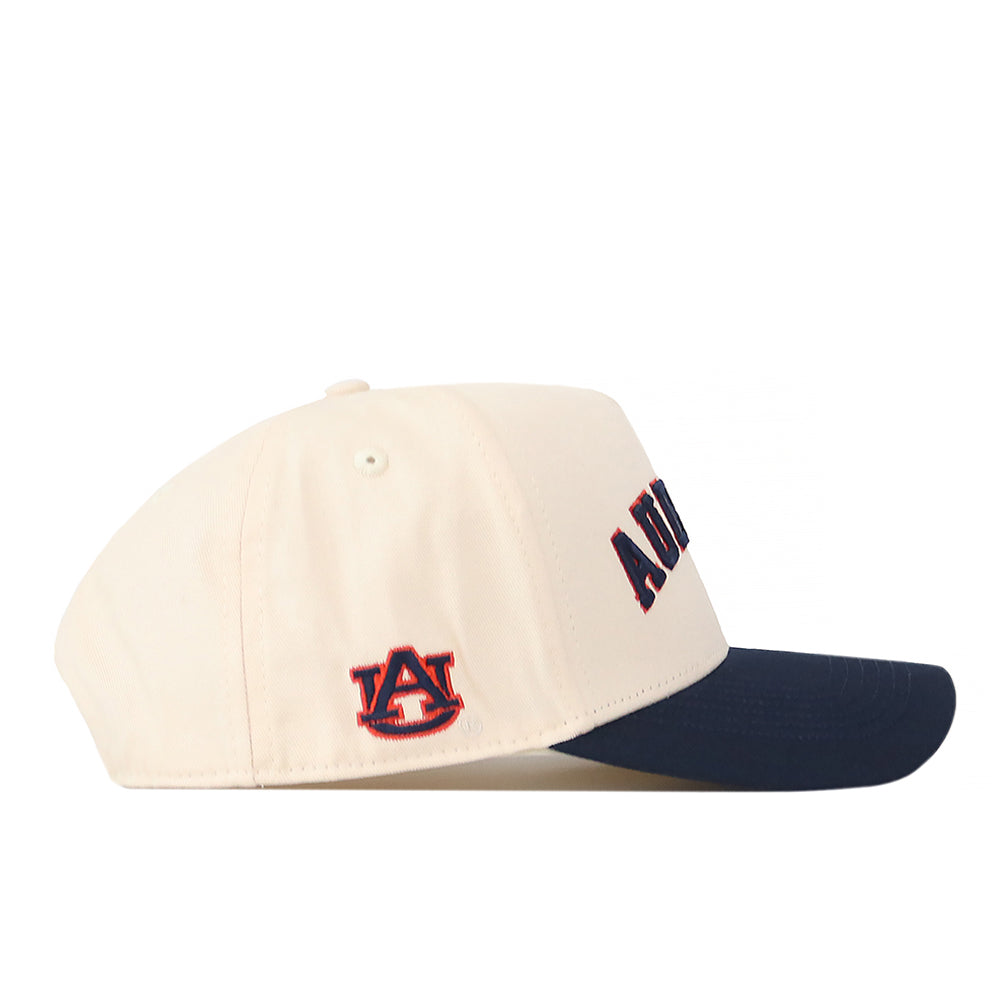 Introducing the Right Side Up Auburn Hat - Classic Colors by No Rivals: This cream-colored baseball cap features a navy brim, AUBURN embroidered on the front, and an embroidered Auburn University logo on the side. The adjustable snap back ensures a comfortable fit for gameday.