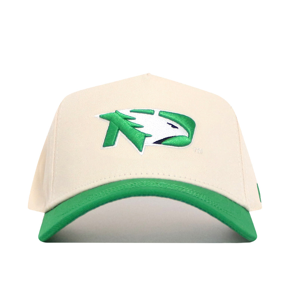 The No Rivals North Dakota Logo Patch Hat is a cream golf hat with a green brim, featuring a green and white abstract eagle head and ND patch on the front. This structured snapback offers stylish comfort.