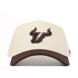 The No Rivals USF Espresso Hat is a beige cotton baseball cap with a brown bull head logo on the front and a brown brim. It features a snap back closure for adjustable fit, displayed on a white background.