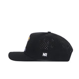The No Rivals Kansas Golf Hat in black is shown from the side, featuring small ventilation holes on the crown, an NR logo patch on the back, and a classic snapback closure.
