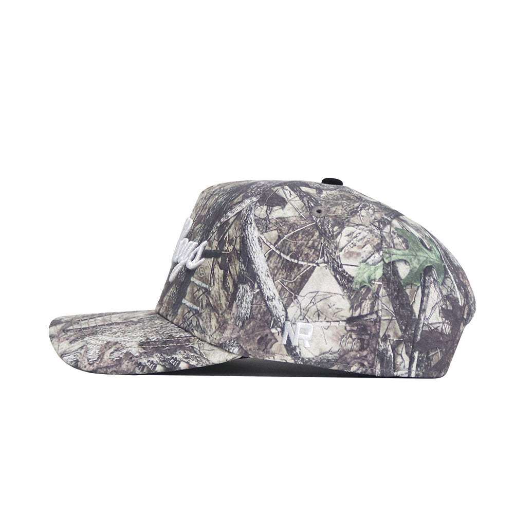 The No Rivals Vandy Boys Outland Hat is a premium cotton snapback with a flat brim, side view. Features white "NR" embroidery on the side panel and an officially licensed green and brown woodland camouflage design.