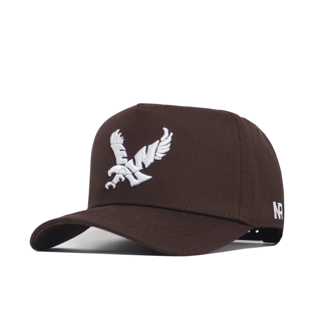 The No Rivals EWU Americano Hat is a dark brown, structured fit baseball cap crafted from high-quality cotton, with a white embroidered eagle on the front and NR letters on the side. Shown from the left front angle on a white background.