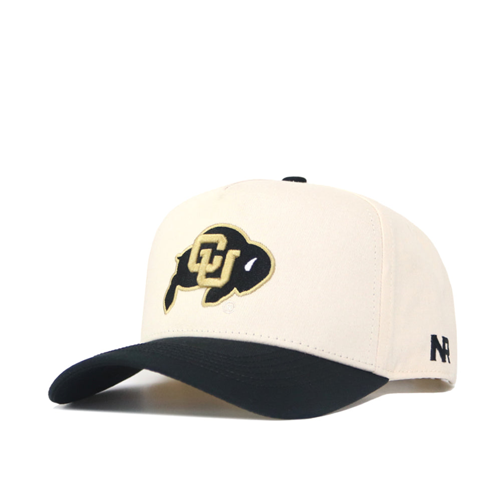 The Classic Colorado Buffs Hat is a beige snapback with a black curved brim, featuring a buffalo CU logo on the front and N R letters in black on the side. Made from high-quality cotton, it offers a structured fit for lasting comfort.