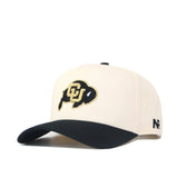 The Classic Colorado Buffs Hat is a beige snapback with a black curved brim, featuring a buffalo CU logo on the front and N R letters in black on the side. Made from high-quality cotton, it offers a structured fit for lasting comfort.