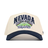 A beige and navy blue No Rivals Nevada Wolf Pack Stadium Hat featuring officially licensed embroidered NEVADA and Wolf Pack logos above an image of a football stadium on the front.