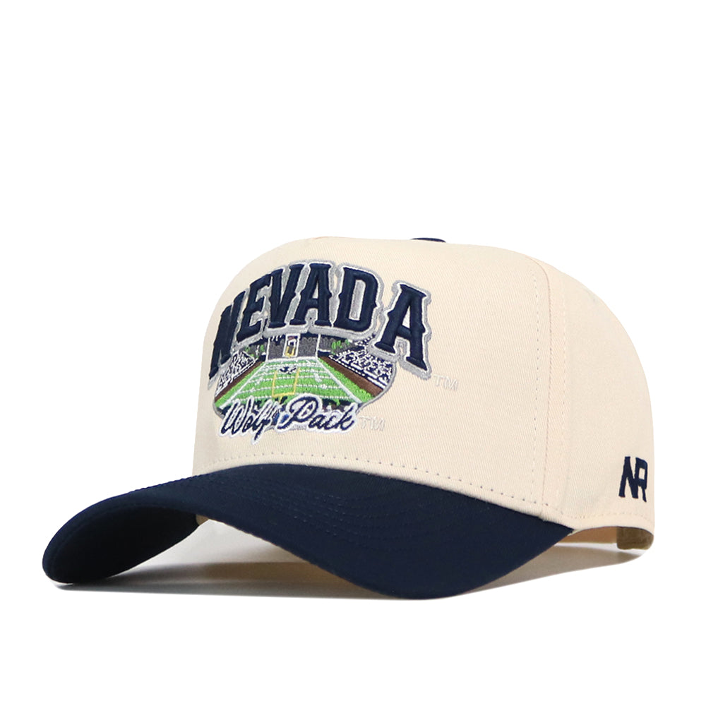 Introducing the Nevada Wolf Pack Stadium Hat by No Rivals—a beige and navy snapback cap featuring bold Nevada Wolf Pack text and a detailed stadium graphic on the front. An embroidered NR logo accents the side, while officially licensed details and expert embroidery give this cap standout style.