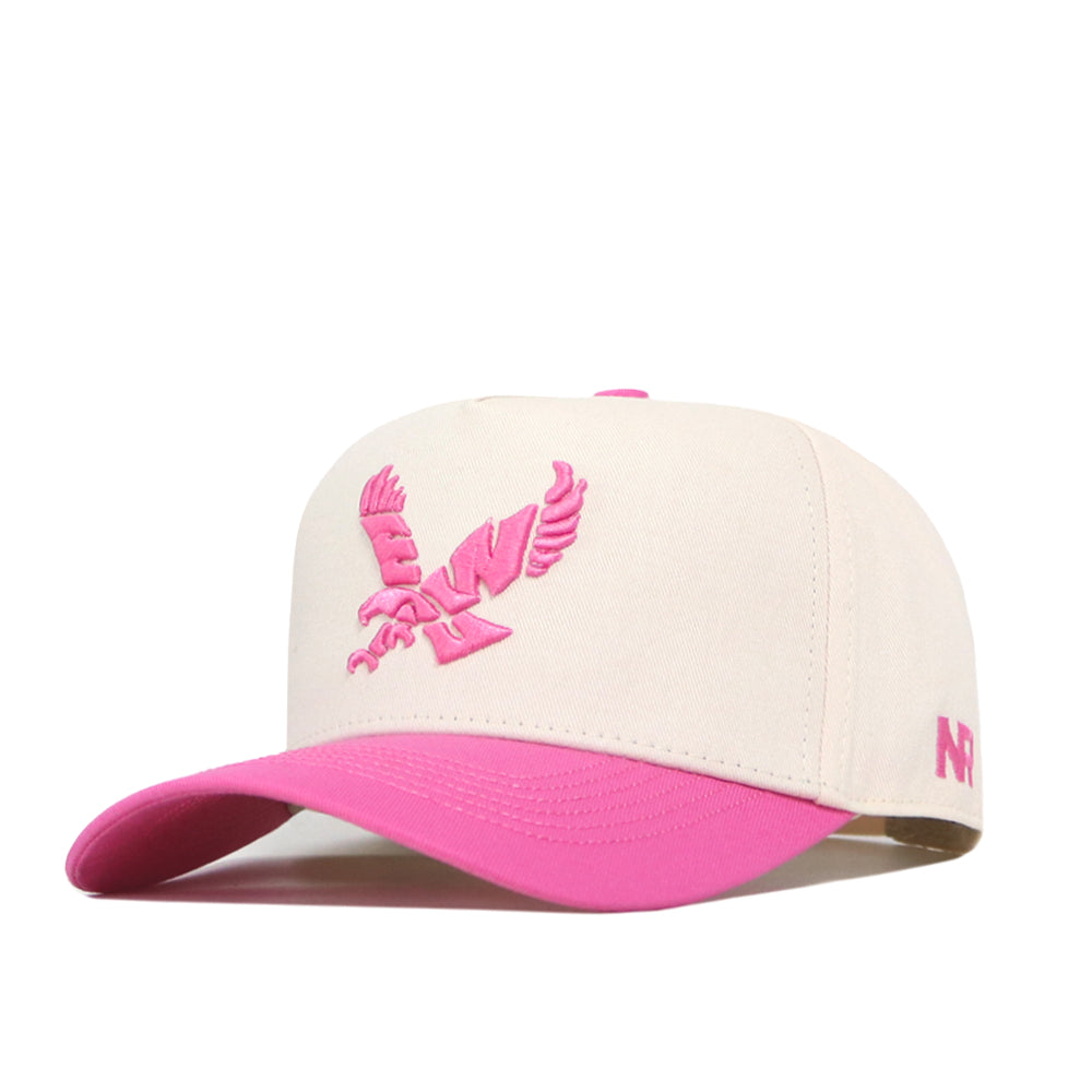 Introducing the EWU Pink Out Hat by No Rivals—a cream-colored baseball cap featuring a pink brim and a pink embroidered eagle logo on the front. Made from performance fabric for all-day comfort, this hat showcases embroidered pink “NR” letters on the side and has a snap-back closure for an adjustable fit.