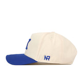 The No Rivals Kentucky Vintage K Hat - Classic features a cream-colored body with a blue brim and blue NR initials embroidered on the side, shown here in a left side profile—perfect for your gameday fit.