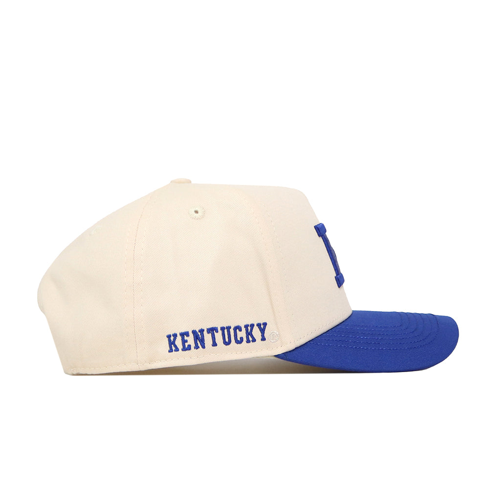 The No Rivals Kentucky Vintage K Hat - Classic is a cream-colored snapback with a blue brim, featuring an embroidered blue KENTUCKY logo on the side—perfect for completing your gameday look.
