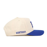 The No Rivals Kentucky Vintage K Hat - Classic is a cream-colored snapback with a blue brim, featuring an embroidered blue KENTUCKY logo on the side—perfect for completing your gameday look.