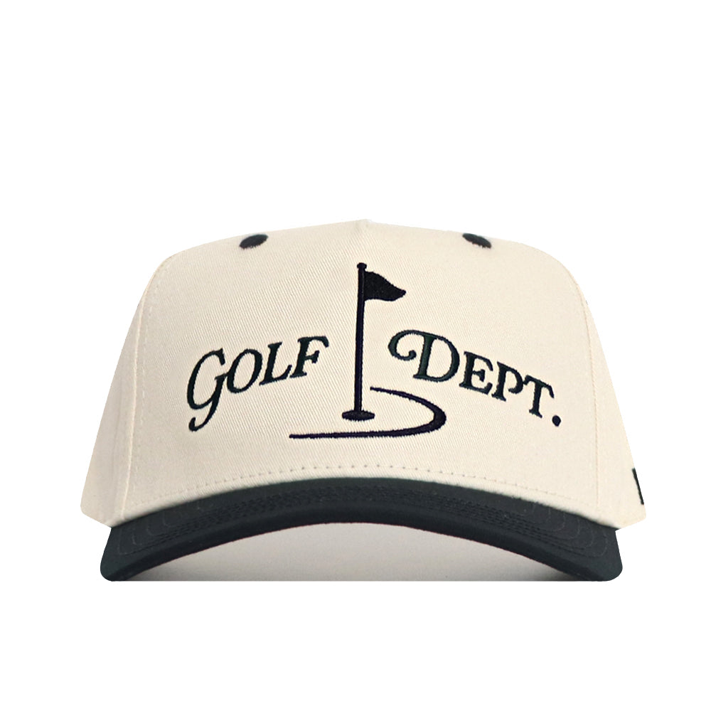 The No Rivals Golf Dept. Hat - Classic Black is a cream snapback with a black brim, crafted from high-quality cotton. The front displays an embroidered "Golf Dept." logo above a golf hole flag and putting green graphic.