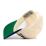 The WVU Mountaineers Script Retro Hat by No Rivals is shown from underneath, displaying its green brim, inner stitching, a No Rivals label, and a QR code on the inside band. This snapback cap features performance fabric for lasting comfort.