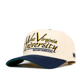 The No Rivals WVU Mountaineers Script Retro Hat is a cream and navy baseball cap made from performance fabric, featuring a snap back closure and the West Virginia University Mountaineers logo embroidered on the front in yellow, black, and blue lettering.