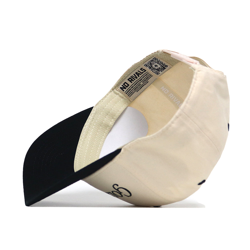 The Golf Dept. Hat - Classic Black by No Rivals features a beige crown, black brim, and high-quality cotton. Turned inside out, it reveals a NO RIVALS label and QR code on the inner band.
