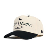 The No Rivals Golf Dept. Hat - Classic Black is a beige cotton blend snapback with a black brim, featuring an embroidered GOLF DEPT. and flagstick graphic on the front and a small “N” accent on the left side of the brim.