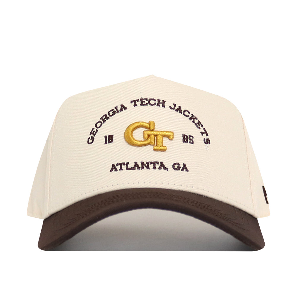 The Georgia Tech Yellow Jackets Outlaw Hat - Classic by No Rivals showcases cream and brown colors with “GEORGIA TECH JACKETS,” “1885,” “GT,” and “ATLANTA, GA” embroidered on the front, featuring a bold logo and an adjustable snap back for the perfect gameday fit.