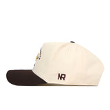 A cream-colored Georgia Tech Yellow Jackets Outlaw Hat - Classic by No Rivals, featuring a dark brown brim and the initials “NR” embroidered in dark brown near the back, is shown from the side. A classic snapback adjustment ensures a perfect fit for gameday.