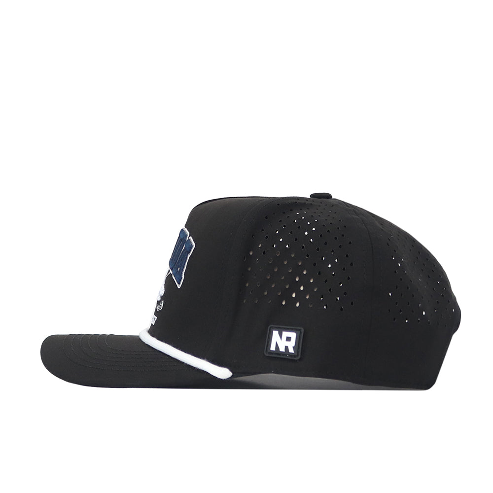 A side view of the Nevada Wolf Pack Golf Hat in black by No Rivals, showcasing small ventilation holes, a flat brim, and a white embroidered Wolf Pack logo on the front. The hat also features a rectangular NR logo patch on the side and is designed for the perfect Gameday Fit, with an adjustable snapback closure for personalized comfort.