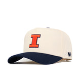 The No Rivals Illinois Logo Patch Hat is a beige cotton snapback with a 3D orange "I" on the front, navy curved brim, and "NR" embroidered in navy on the left side.